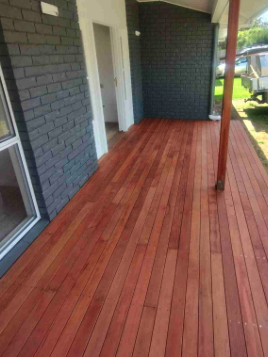 Stained porch decking against a Louisville Victorian brick wall